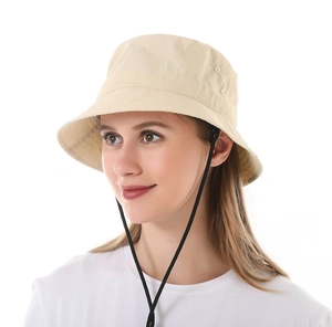 Detail of beige sun hat with adjustable black chin strap for outdoor activities