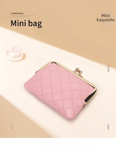 Close-up of pink quilted mini coin purse with metal clasp and elegant stitching