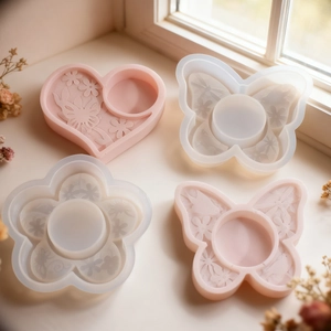 Macro shot of relief flower heart and butterfly silicone molds for resin casting