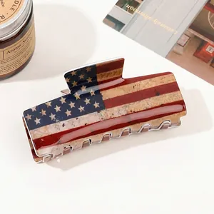 Detailed view of a large hair claw clip featuring a vintage American flag pattern design