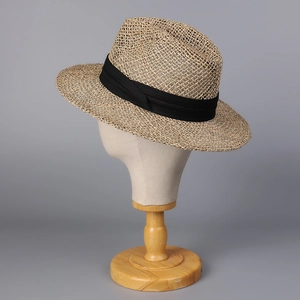 Classic straw boater hat with black ribbon on a mannequin head stand