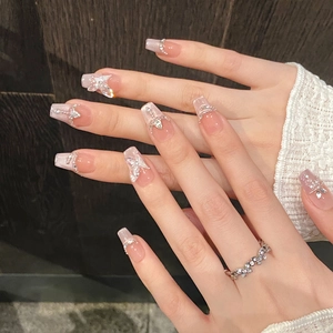 Sparkly butterfly press-on nails with cat eye effect, rhinestones and pearls on long coffin tips