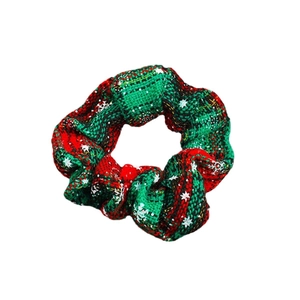 Christmas scrunchie with red and green plaid fabric and white snowflake patterns