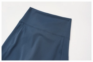 Close-up of high-waist yoga shorts showing durable flatlock stitching in dark blue
