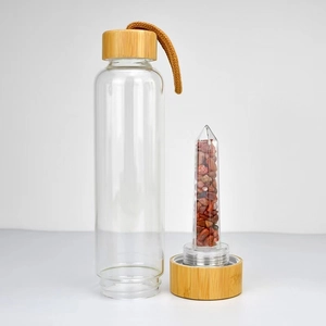 Crystal energy glass water bottle with bamboo lid, red quartz stones and carry strap