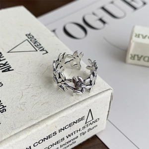 Close-up of vintage S925 sterling silver open ring with intricate floral daisy pattern