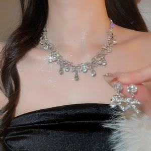 Elegant silver necklace set with teardrop waterdrop diamonds worn by a model