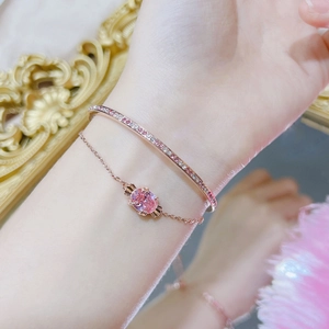 Rose gold jewelry set with pink crystal bracelet and zircon bangle on female wrist