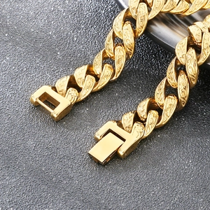 Macro shot of gold Cuban chain bracelet featuring intricate vintage floral engravings