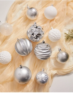 Macro detail of silver and white Christmas tree ornaments with textured relief patterns
