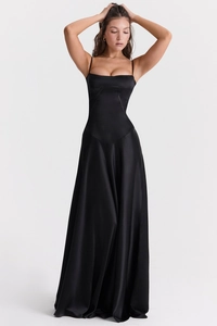 Detail of elegant black satin slip dress showing spaghetti straps and structured corset bodice