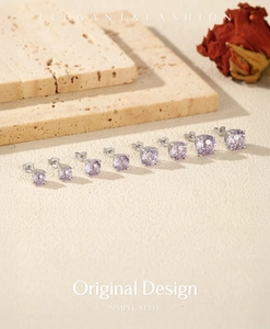 Elegant lavender fireworks cut silver earrings in multiple sizes on textured stone