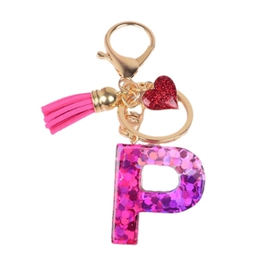 Pink resin letter P keychain with glitter, magenta tassel and red heart charm on gold ring