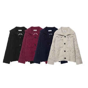 Detail view of hollow knit cardigans in black, burgundy, navy, and cream white colors