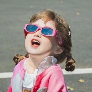 Pink square frame kids sunglasses with blue lenses and silver Lucky lettering on temple