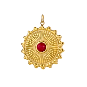 Detail of a vintage sunburst pendant with a red gemstone in gold-plated stainless steel