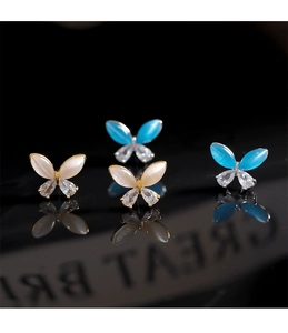 Macro shot of 925 silver needle butterfly earrings with opal stones and rhinestone details