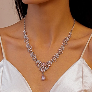 Close-up of sparkling pink rhinestone drop pendant necklace on model's neckline
