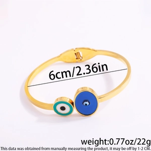 Detail shot of gold evil eye bangle showing dimensions 6cm diameter and 22g weight
