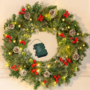 Detail of Christmas wreath with flocking, red berries, pine cones and LED battery box