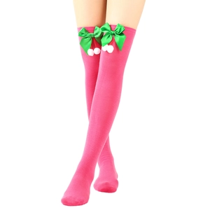 Detail of pink Christmas over-knee socks with green bow and white pom-pom decoration