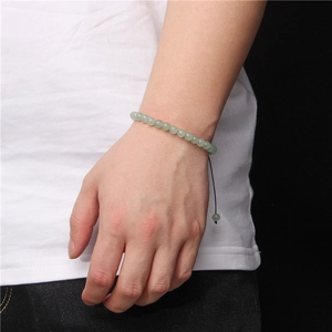 Detail of 6mm natural green stone beaded bracelet with adjustable black braided cord