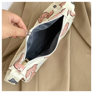 Close-up of cute cartoon bear canvas bag showing gray lining and secure zipper closure