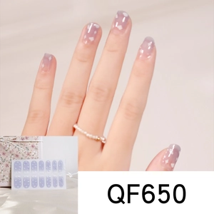 Detail of purple cow heart nail stickers with cloud patterns and floral packaging