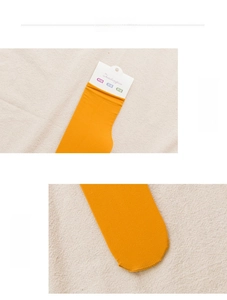 Detail of ginger velvet crew socks showing elastic cuff and seamless toe construction