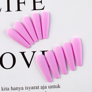 Detail view of pink matte long coffin fake nails with smooth frosted finish texture