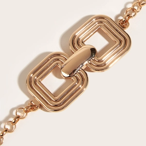 Macro shot of interlocking golden metal buckle with polished chain links for dresses