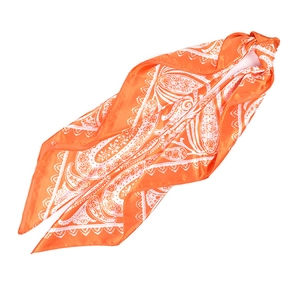 Detail of orange satin square scarf with white paisley pattern and silk texture