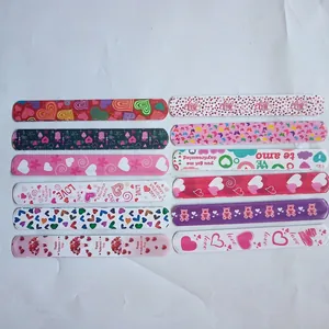 Set of 12 Valentine's Day snap bracelets with colorful heart patterns for party favors