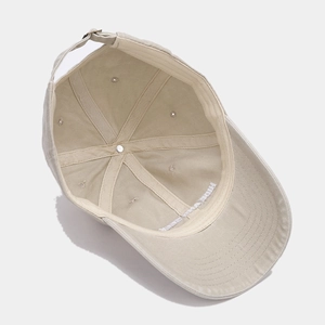 Detail of internal six-panel structure and adjustable metal buckle on beige cotton cap