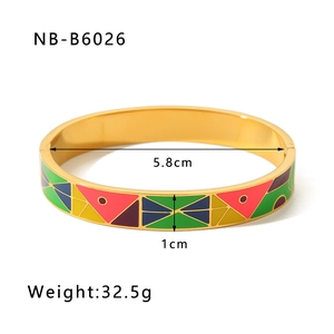 Macro view of 18k gold plated enamel bangle featuring colorful geometric patterns