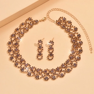Elegant gold metal jewelry set with dark crystal necklaces and dangling earrings