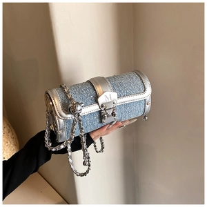 Blue denim barrel bag with sparkling rhinestones and silver chain strap in Y2K style