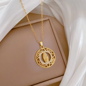 Close-up of gold round portrait pendant necklace with sparkling crystals on silk background