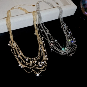 Detail of multi-layered tassel necklace with sparkling zircon stones in gold and silver