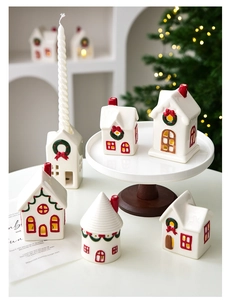 Detail of Christmas ceramic house candle holder with white walls and red festive roof decor