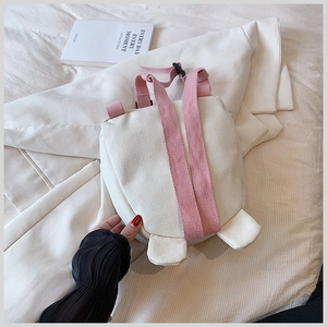 Top view of cream canvas toddler backpack with pink straps and cute turtle shell design