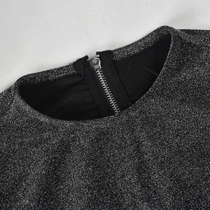 Detailed macro view of the high-stretch silver silk fabric and metallic zipper closure