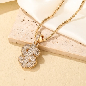 Detail of gold dollar sign pendant with sparkling zircons on a twisted rope chain