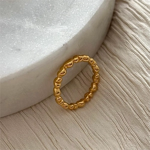 Minimalist 925 sterling silver heart ring in golden finish on white marble background