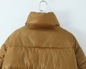 Detailed view of the brown puffer jacket showing quilted layers and a stand collar