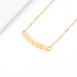 Macro detail of 18K gold titanium steel necklace with honeycomb diamond pendant