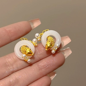 Detailed view of handmade koi fish earrings with white resin rings and tiny pearls