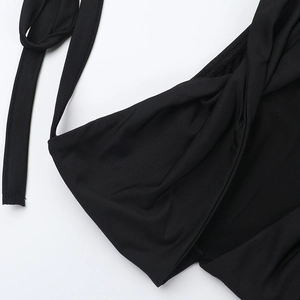 Detail of the black halter neck design with a stylish hollow metal buckle and knot twist