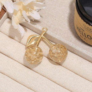 Elegant gold cherry pendant with gold foil resin and metallic stem in jewelry box