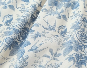 Close-up of blue and white floral fabric with bird prints for French vintage dress